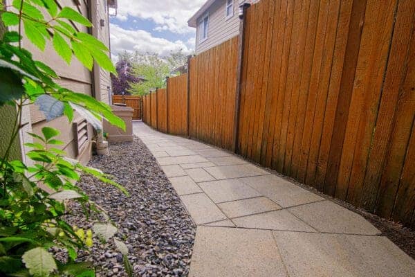 Stone paver patio seamlessly integrated with maintained lawn for entertaining in Redmond residential landscape design