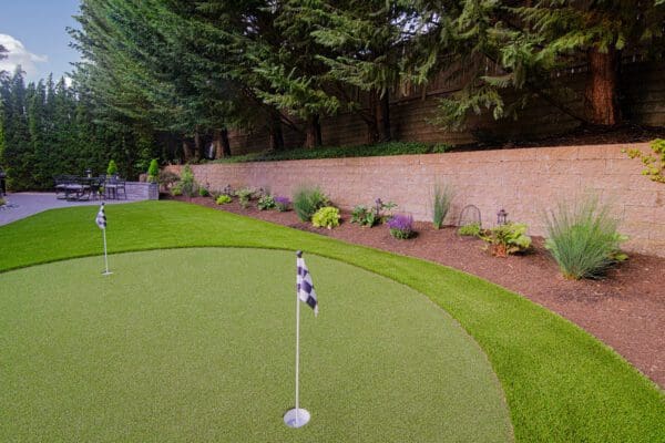Lush garden plantings along lawn border creating natural privacy screening in Redmond WA landscape project