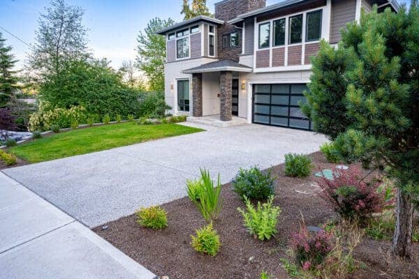 Spacious backyard with manicured lawn and stone patio for outdoor living in Kenmore WA landscape renovation