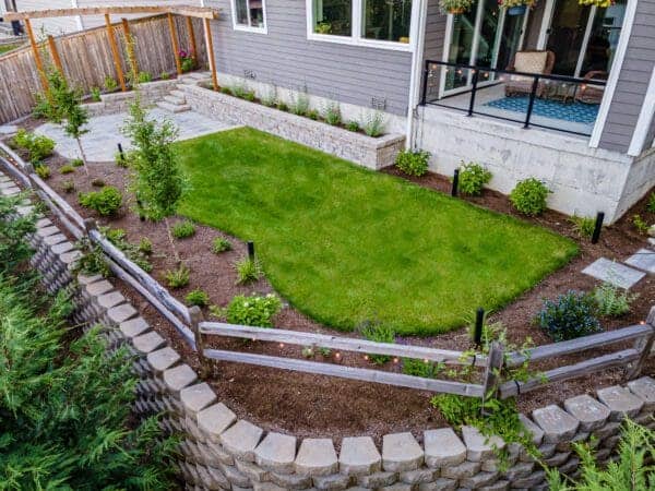 Natural stone retaining wall with textured masonry detail in Kenmore WA residential landscape project by Classic Landscaping
