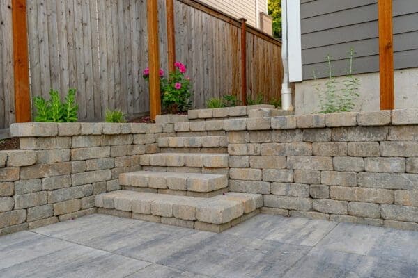 Decorative stone wall accent blending hardscape with softscape in Kenmore residential landscape renovation