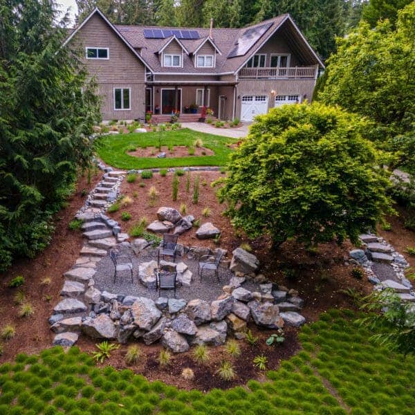 Sloped yard transformation with natural stone steps and terraced plantings in Sammamish WA by Classic Landscaping