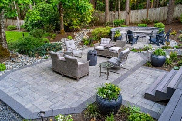 Residential residential landscape project detail showing natural stone fire pit by Classic Landscaping