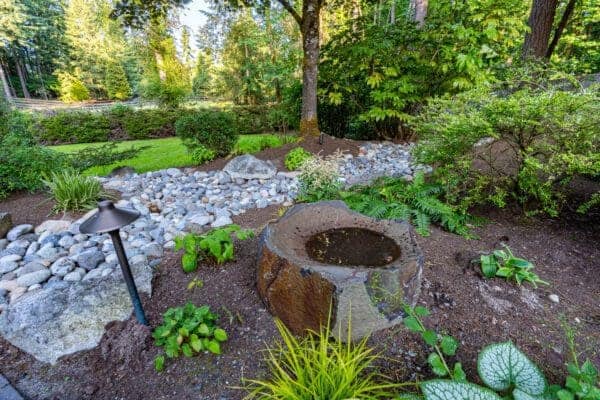 Residential residential landscape project detail showing river rock borders by Classic Landscaping