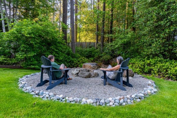 Natural stone fire pit in a Seattle-area residential landscape for article on 6 Fire Pit Design Ideas for Seattle