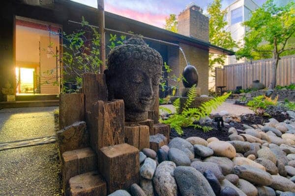 Outdoor living space with Japanese-inspired garden plantings by Classic Landscaping in West Seattle