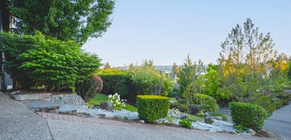 Curved garden pathway lined with ornamental grasses and perennials in lakeview residential landscape