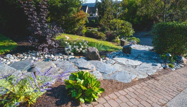 Lakeview Landscape featuring stone pathways and lake views by Classic Landscaping