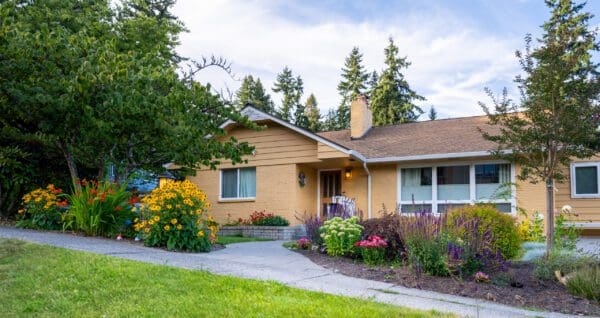 Outdoor entertainment patio surrounded by lush garden plantings in Greater Seattle residential landscape design by Classic Landscaping