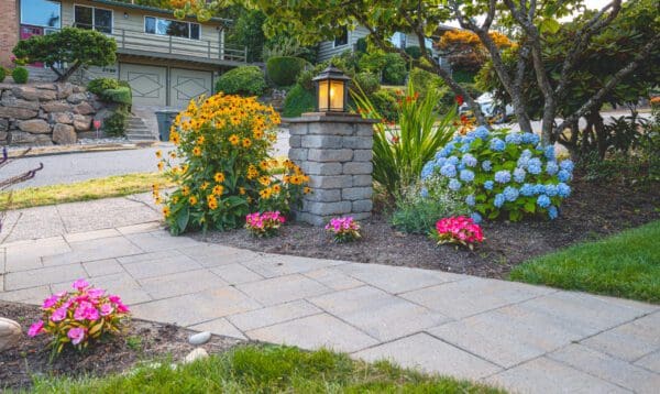 Garden room with mature ornamental plantings creating intimate outdoor entertainment space by Classic Landscaping