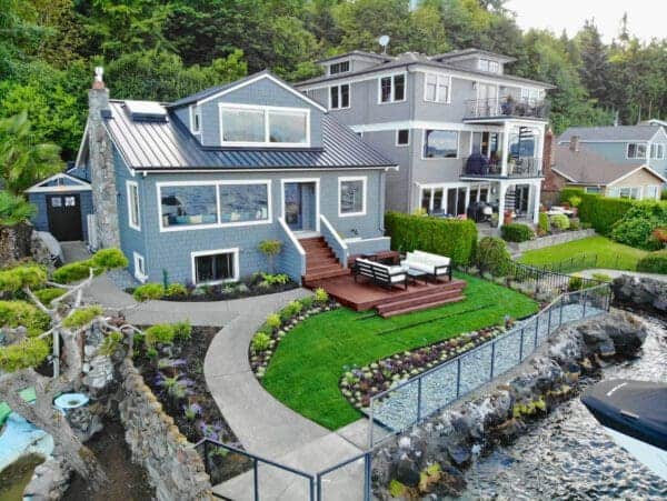 Lakefront Landscape featuring stone pathways and waterfront garden by Classic Landscaping