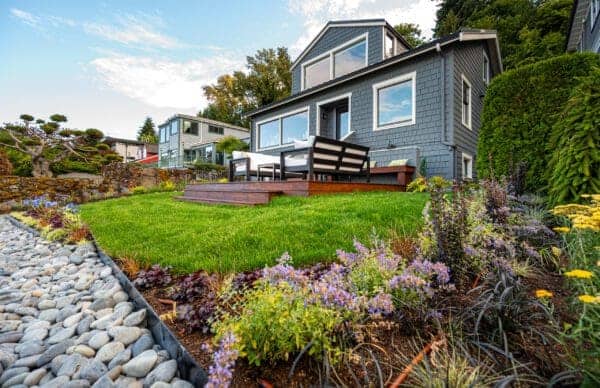 Lakefront Landscape featuring stone pathways and waterfront garden by Classic Landscaping