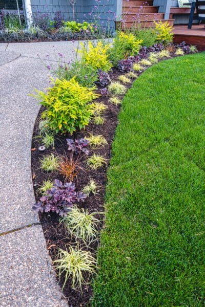Lakefront Landscape featuring stone pathways and waterfront garden by Classic Landscaping