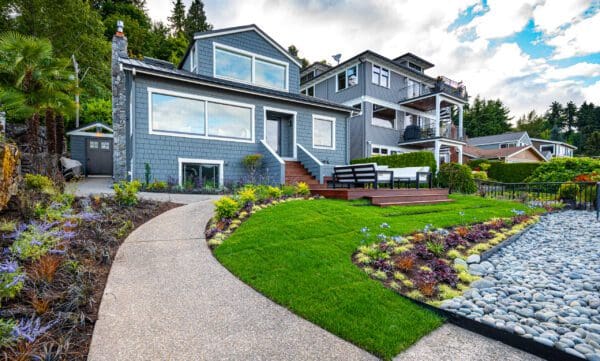 Lakefront Landscape featuring stone pathways and waterfront garden by Classic Landscaping