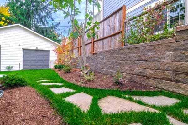 Landscape Makeover featuring water views and natural plantings by Classic Landscaping