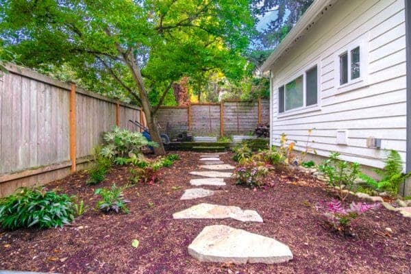 Landscape Makeover featuring water views and natural plantings by Classic Landscaping
