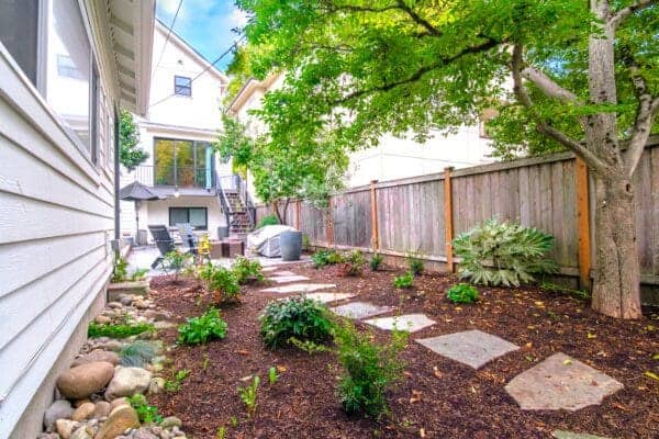 Landscape Makeover featuring water views and natural plantings by Classic Landscaping