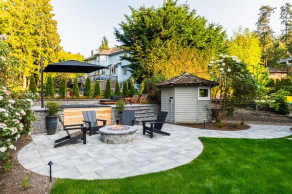 Terraced landscape design transforming sloped Bellevue backyard into functional outdoor living spaces with retaining walls